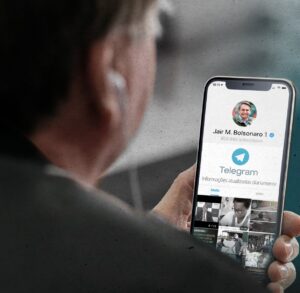 Brazil’s President Jair Bolsonaro looking at his Telegram channel on a mobile phone.